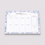 Weekly planner with floral design on a gray background
