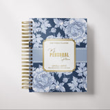 Floral-patterned planner with gold accents on a light gray background