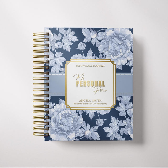 Floral-patterned planner with gold accents on a light gray background